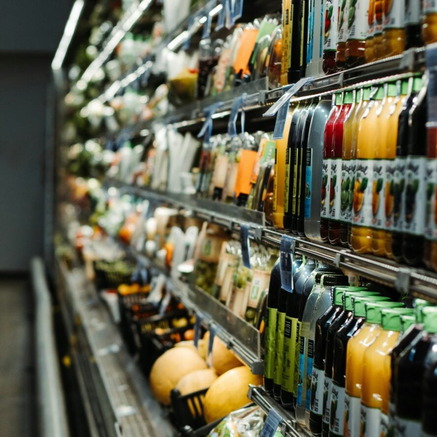 Chiller cabinet in supermarket packed with drinks